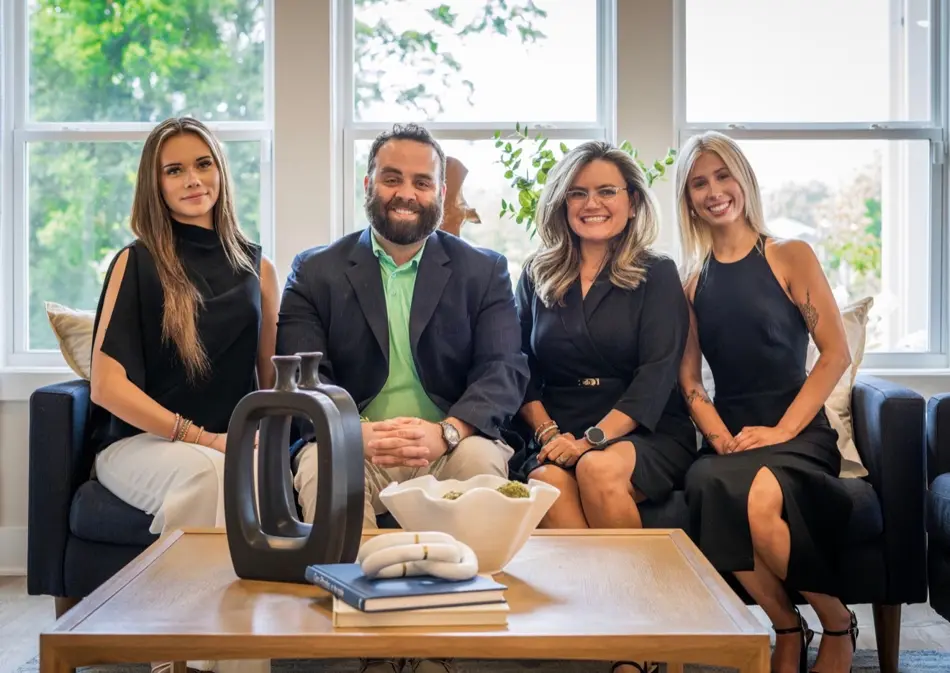 The Green Arc Properties team together in a bright living room
